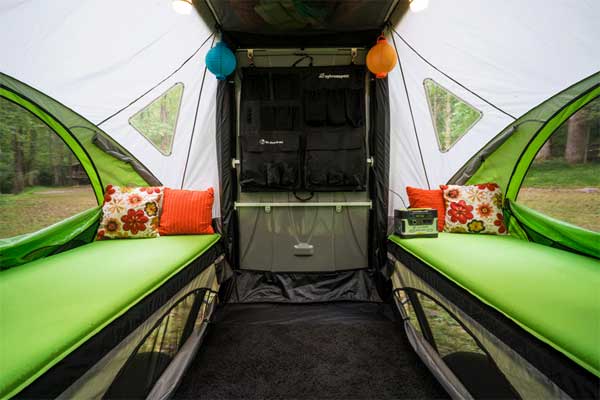 Inside the SylvanSport GO Camping Trailer with Convertible Table and Beds for 4 People
